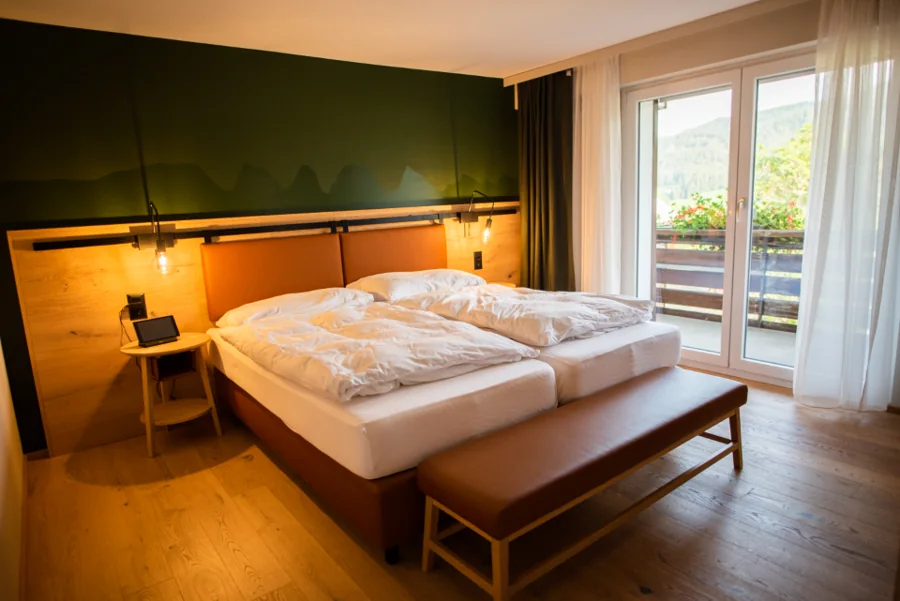 A clean, bright bedroom with a large window
